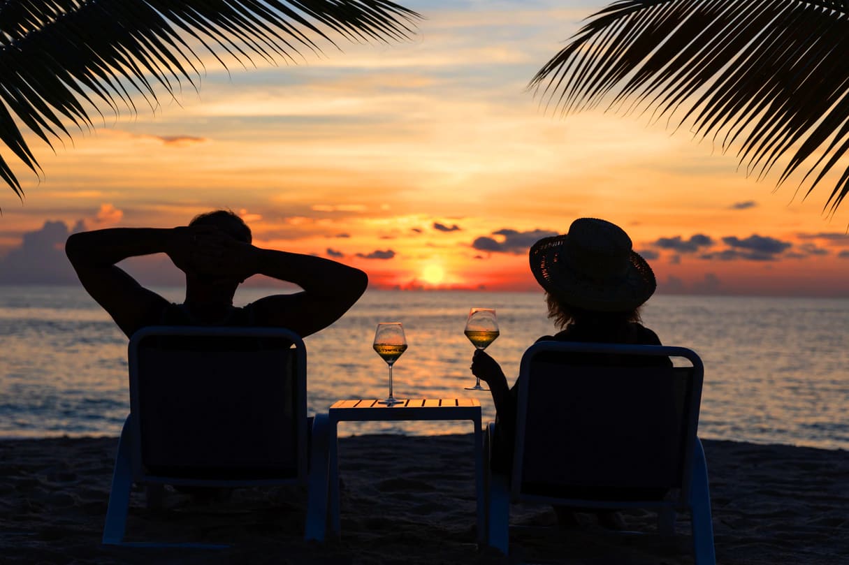 The Westin Seven Mile Beach Resort _ Spa couple having cocktail at sunset